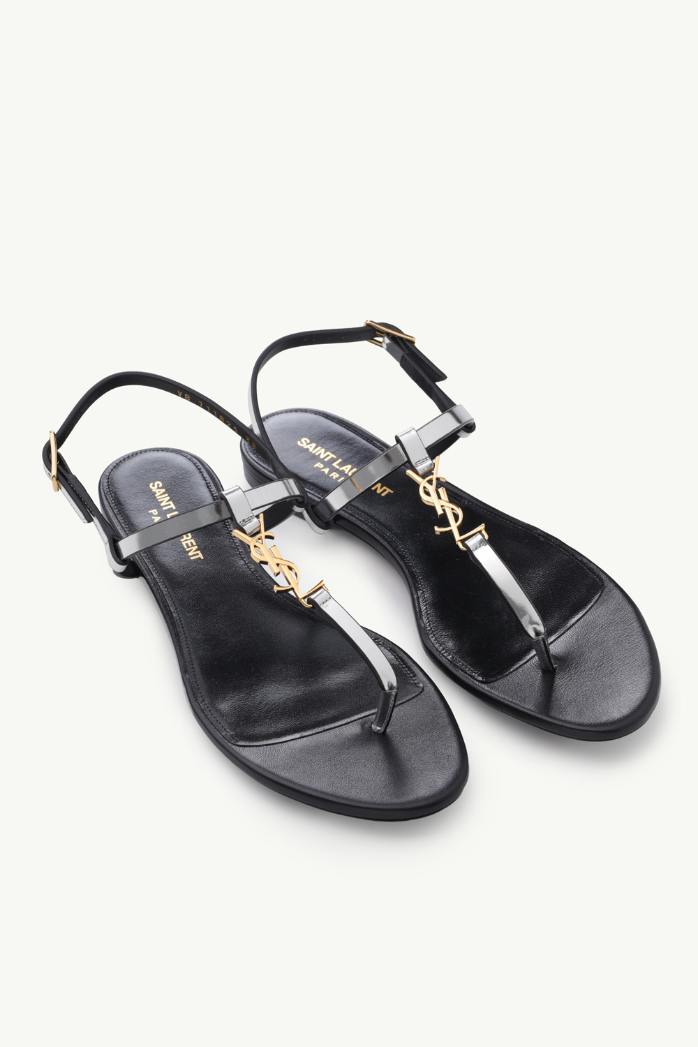 SAINT LAURENT Women Cassandra Flat Ankle Strap Sandals in Argent Reflective Leather with Gold-Tone Monogram 1